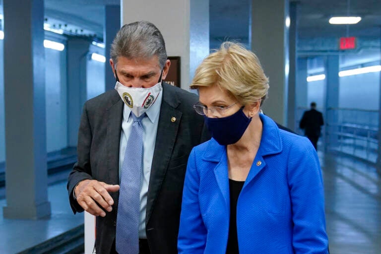 Sen. Joe Manchin, D-W.Va., left, speaks with Sen. Elizabeth Warren, D-Mass., on Capitol Hill in Washington, Wednesday, Oct. 27, 2021. (AP Photo/Patrick Semansky)