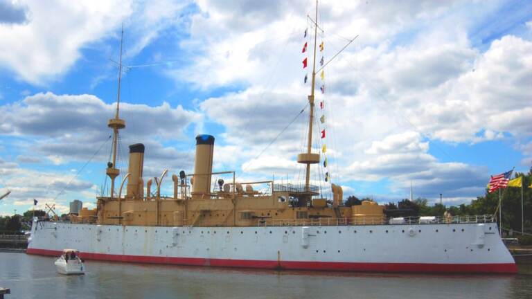 xThe USS Olympia on display as a museum ship on the Delaware River near Penn's Landing in Philadelphia. (Wikimedia Commons)