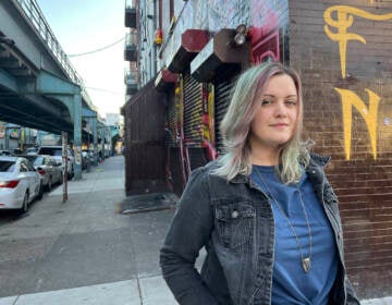 Amy Hartranft stands under the El in Philadelphia