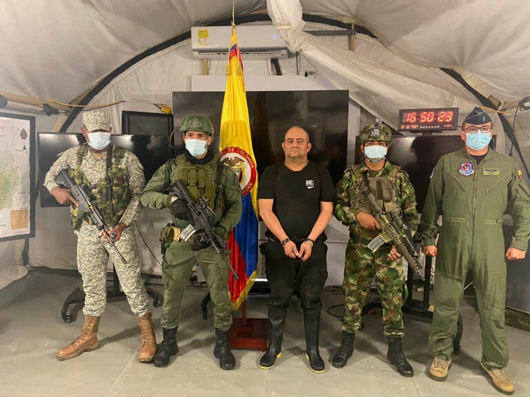 In this photo released by the Colombian presidential press office, one of the country’s most wanted drug traffickers, Dairo Antonio Usuga, alias “Otoniel,” leader of the violent Clan del Golfo cartel, is presented to the media at a military base in Necocli, Colombia, Saturday, Oct. 23, 2021.  (Colombian presidential press office via AP)