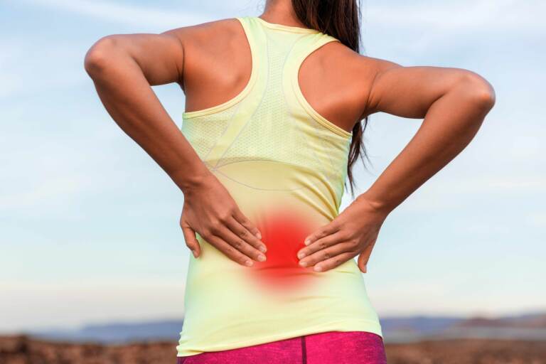 A woman with inflammed area in red halo on her lower back