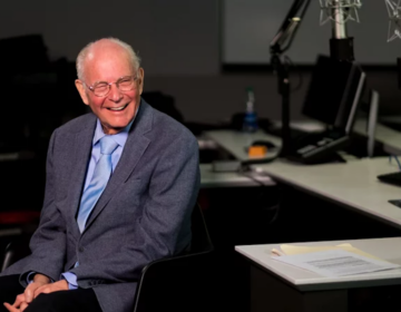 Bill Siemering sits at a desk