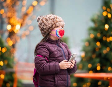 A child walks by a Christmas display