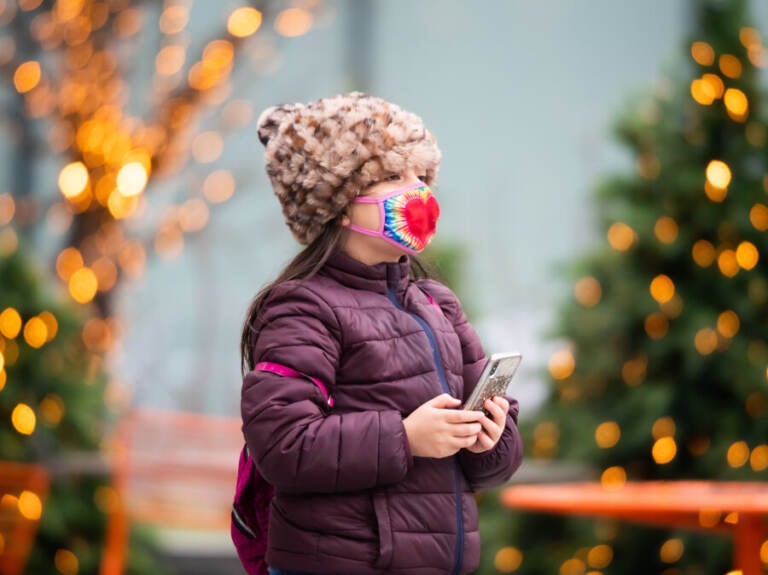 A child walks by a Christmas display