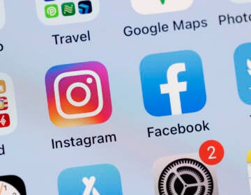 In this photo illustration, the Facebook and Instagram apps are seen on the screen of an iPhone