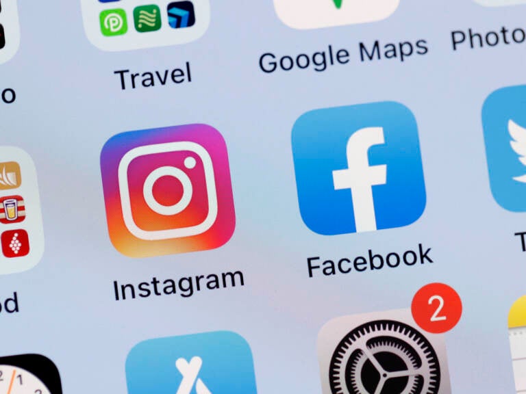 In this photo illustration, the Facebook and Instagram apps are seen on the screen of an iPhone