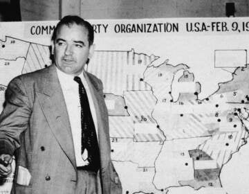 Sen. Joseph McCarthy, R-Wis., testifies during hearings in Washington, D.C., on June 9, 1954. McCarthy stands before a map that charts alleged communist activity in the United States. (Getty Images)