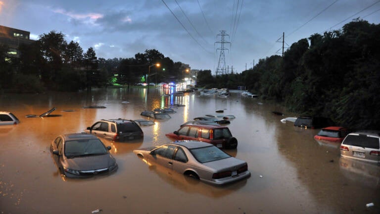 Cars submerged in floodwaters in a parking lot