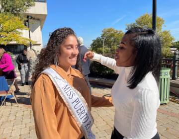 Former foster kids Mayda Berrios (left) and Daykia McKnight were all smiles after the bill to pay all college costs was signed into law. (Cris Barrish/WHYY)