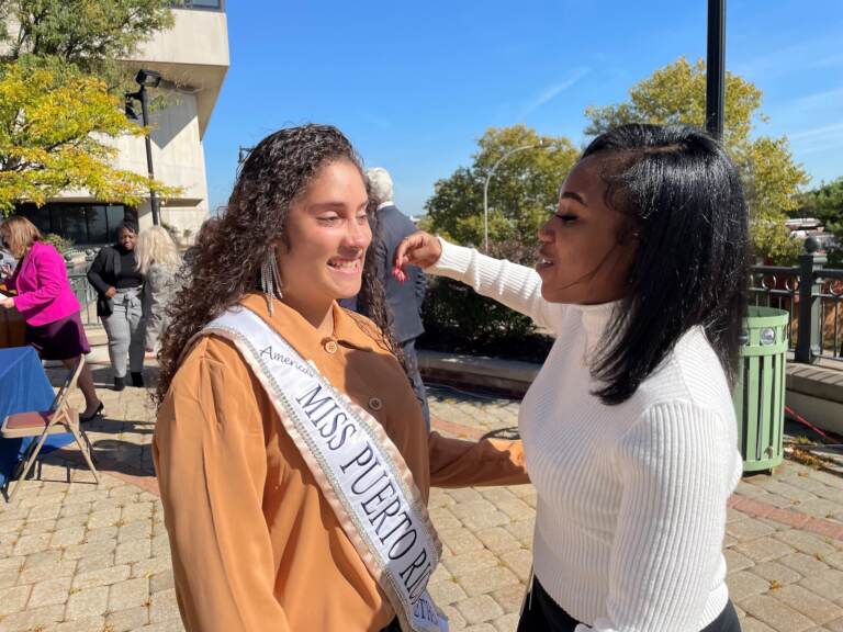 Former foster kids Mayda Berrios (left) and Daykia McKnight were all smiles after the bill to pay all college costs was signed into law. (Cris Barrish/WHYY)