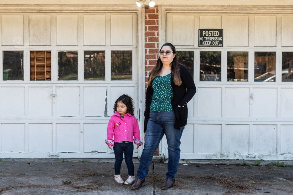 Erica Cuellar and her daughter Sara Alvarado pose for a portrait in front of their home