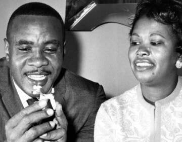 Sonny Liston holds a china dog from his collection as he sits with his wife Geraldine