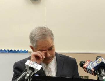 Philadelphia District Attorney Larry Krasner wipes his eyes after speaking about the shooting of a pregnant woman over the weekend. (Tom Mac Donald/WHYY)