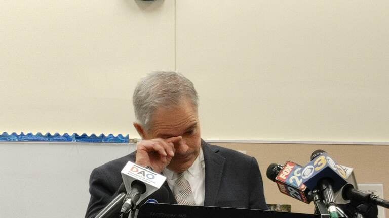 Philadelphia District Attorney Larry Krasner wipes his eyes after speaking about the shooting of a pregnant woman over the weekend. (Tom Mac Donald/WHYY)