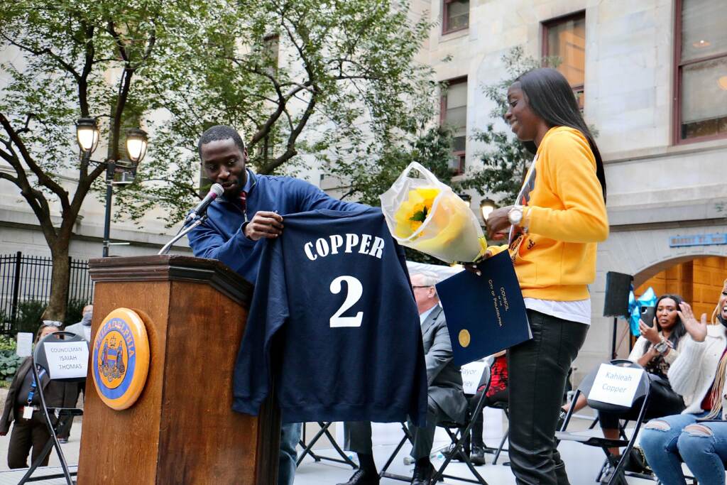 Isaiah Thomas presents Kahleah Copper with a shirt