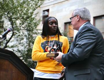 Philadelphia Mayor Jim Kenney presents a Liberty Bell award to Kahleah Copper, the 2021 WNBA Finals MVP, at a ceremony at City Hall. (Emma Lee/WHYY)