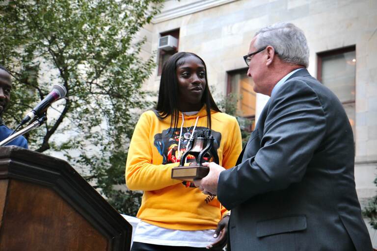 Philadelphia Mayor Jim Kenney presents a Liberty Bell award to Kahleah Copper, the 2021 WNBA Finals MVP, at a ceremony at City Hall. (Emma Lee/WHYY)