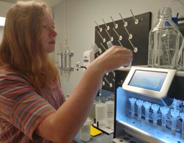 Research associate Jess Anton prepares samples with automated sample preparation equipment. (Zoë Read/WHYY)