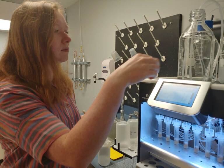 Research associate Jess Anton prepares samples with automated sample preparation equipment. (Zoë Read/WHYY)