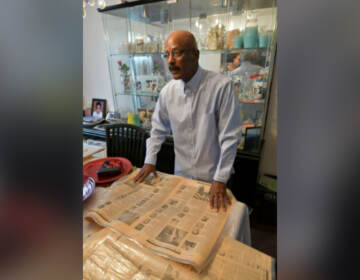 Robert Davis of West Oak Lane looks at his collection of newspapers that chronicled the loss of lives of Vietnam War troops who were Edison High School students. (Abdul R. Sulayman / The Philadelphia Tribune)