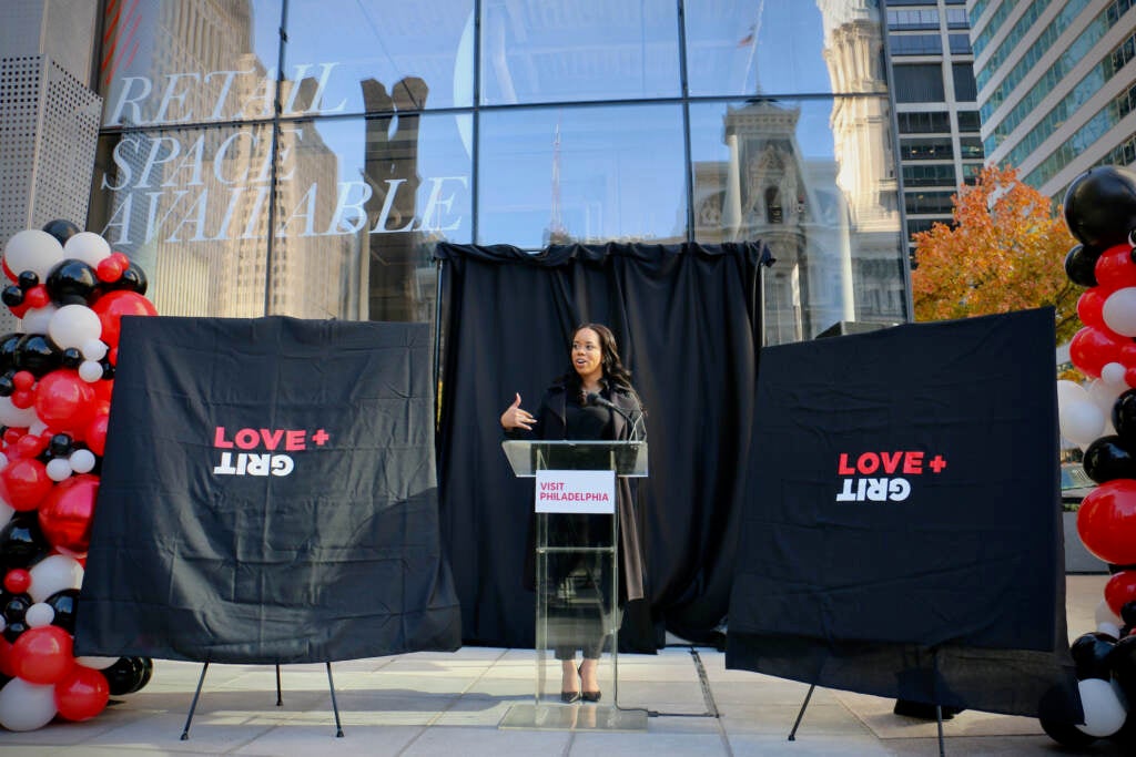 Rachel Ferguson, chief innovation and global diversity officer for Visit Philadelphia, prepares to unveil three artworks that are part of the Love + Grit Storefronts project