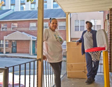 Consuela Estillero and Sid Bolling stand on a front porch