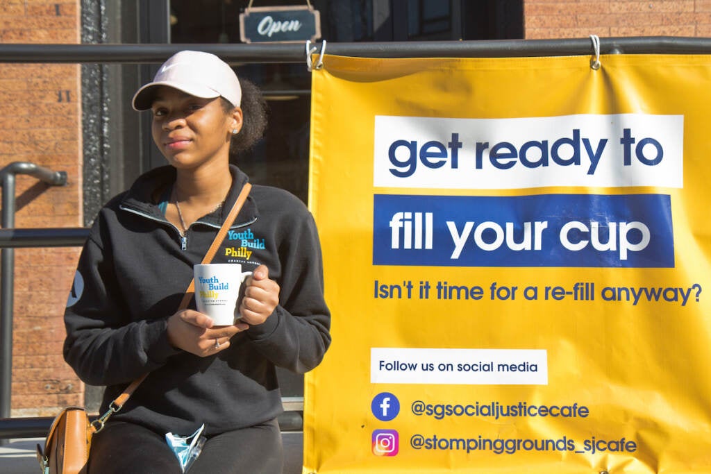 Nyasia Flowers, a 12th grade student at YouthBuild Charter High School, works at the Stomping Grounds Social Justice Cafe in West Philadelphia