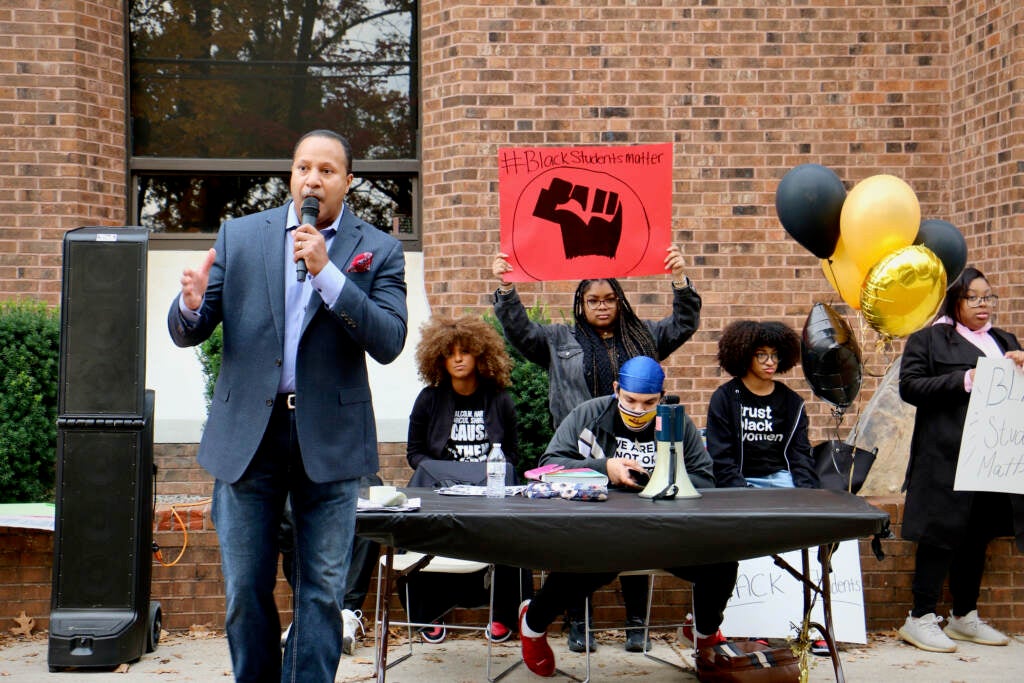 Terrence Jones (left), founder and executive director of Total Justice Project, speaks to students at Rowan University, where his daughter is a student