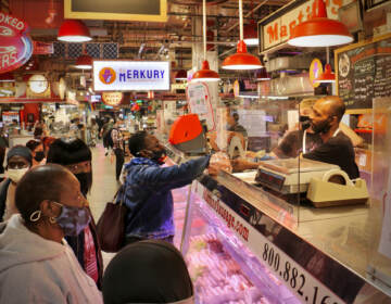 Customers line up at the meat counter