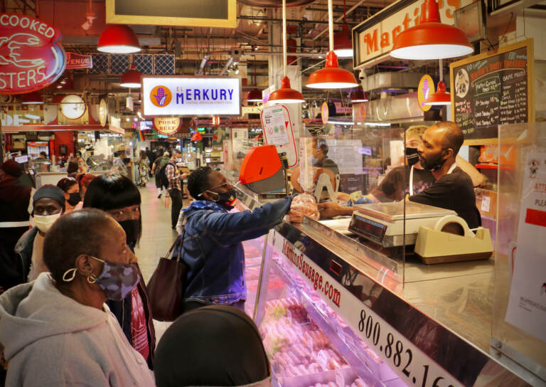 Customers line up at the meat counter