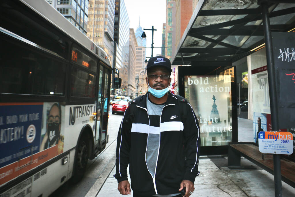 Roland Chambers stands next to a SEPTA bus