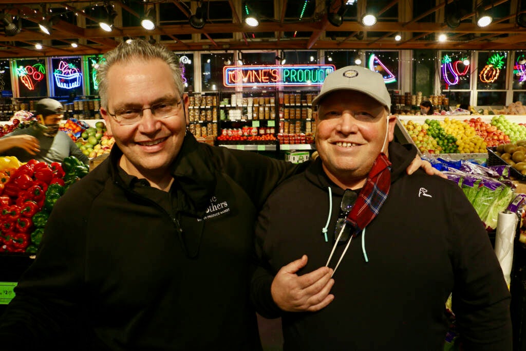 Vinnie (left) and Jimmy Iovine smile inside their produce market