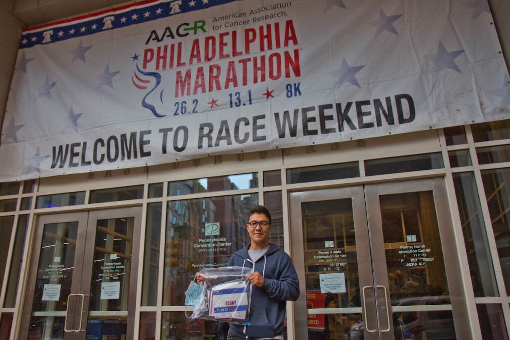 Ghulam Sakhi Danish holds up his bib for the Rothman 8k race on Nov. 19, 2021. He arrived in the U.S. as a refugee from Afghanistan in August 2021, where he lived in a camp in Indiana until coming to Philadelphia this week