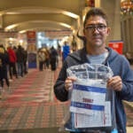 Ghulam Sakhi Danish holds up his bib for the Rothman 8k race on Nov. 19, 2021. He arrived in the U.S. as a refugee from Afghanistan in August 2021, where he lived in a camp in Indiana until coming to Philadelphia this week