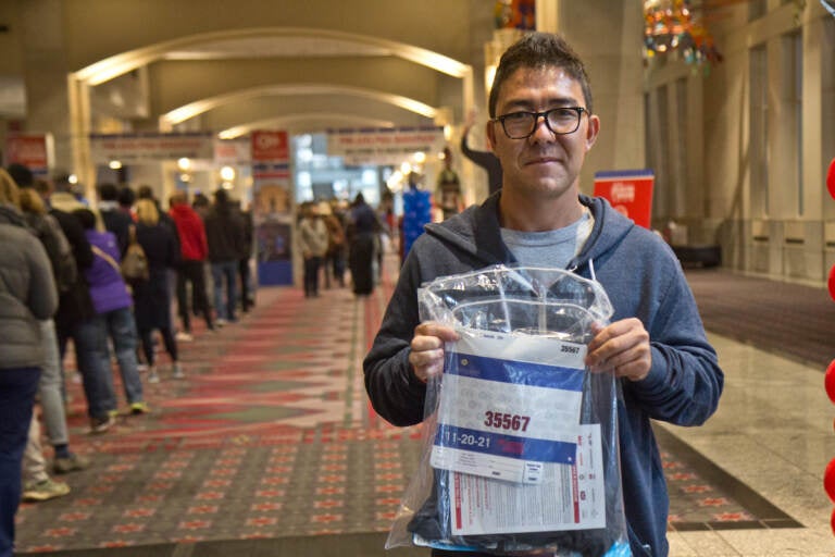 Ghulam Sakhi Danish holds up his bib for the Rothman 8k race on Nov. 19, 2021. He arrived in the U.S. as a refugee from Afghanistan in August 2021, where he lived in a camp in Indiana until coming to Philadelphia this week