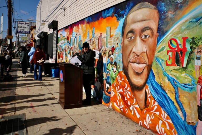 Mural Arts Executive Director Jane Golden opens the dedication ceremony for a George Floyd tribute mural in Philadelphia's Olney neighborhood. The mural was painted by local artist Randal Whitfield on the wall of Tang Pharmacy at 5th Street and West Olney Avenue