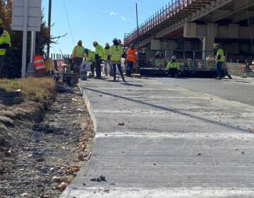 Construction workers rebuild an I-95 off ramp on the city of Wilmington as part of the massive 'Restore the Corridor' interstate project through the city. (Mark Eichmann/WHYY)