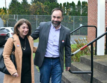 Kevin Brobson walks with his wife, Lauren