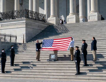 Former sentinels are joined by the Ceremonial Unit of the U.S. Capitol Police for a flag folding observance at the Capitol