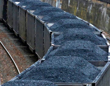 Hold for Business Photo-- Swayne Hall--A Norfolk Southern freight train hauling coal makes it way through downtown Pittsburgh Thursday, Jan. 26, 2017.  (AP Photo/Gene J. Puskar)