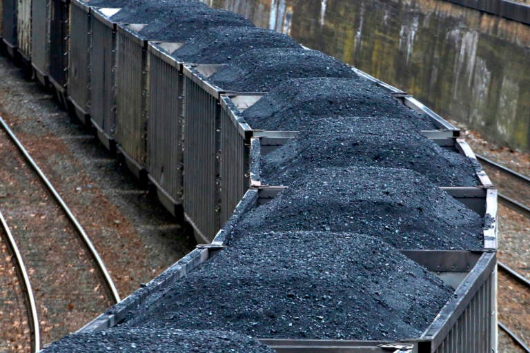 Hold for Business Photo-- Swayne Hall--A Norfolk Southern freight train hauling coal makes it way through downtown Pittsburgh Thursday, Jan. 26, 2017.  (AP Photo/Gene J. Puskar)