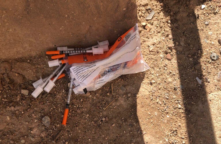 A package of unused syringes and needles is found next to a vacant building in northeast Albuquerque, New Mexico, where crews attempted to clear the lot of used needles and other heroin paraphernalia on Friday, Aug. 9, 2019. Bernalillo County officials have launched a digital mapping tool to track the places where heroin needles and syringes are found in New Mexico's largest city