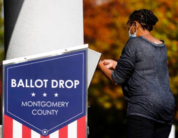 A person drops off a mail-in ballot at an election ballot return box in Willow Grove, Pa., Monday, Oct. 25, 2021.