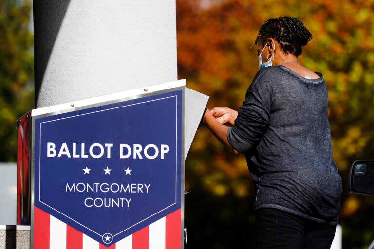 A person drops off a mail-in ballot at an election ballot return box in Willow Grove, Pa., Monday, Oct. 25, 2021. (AP Photo/Matt Rourke)
