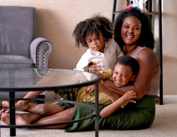 Kisha Gulley appears with her sons Sebastian, 2, left, and Santana, 5, Friday, Sept. 3, 2021 in Phoenix. Gulley is an Instagram influencer and blogger who generates income from her content. (AP Photo/Matt York)