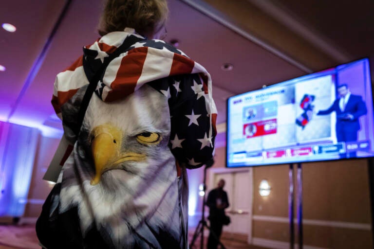 A person wearing an eagle on the back of their hoodie watches the incoming results for New Jersey at the election night party for Republican gubernatorial candidate Jack Ciattarelli, held at the Bridgewater Marriott hotel in Bridgewater, N.J., Tuesday, Nov. 2, 2021