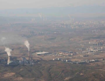 Smoke and steam rise from towers at the coal-fired Urumqi Thermal Power Plant in Urumqi in western China’s Xinjiang Uyghur Autonomous Region, Wednesday, April 21, 2021. China, the world's biggest coal user, said Tuesday the fossil fuel will play a less dominant role in its energy mix and that, despite plans to build new coal-fired power plants, the country won't use it on a wide scale