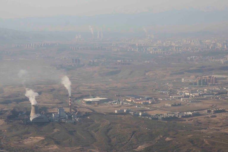 Smoke and steam rise from towers at the coal-fired Urumqi Thermal Power Plant in Urumqi in western China’s Xinjiang Uyghur Autonomous Region, Wednesday, April 21, 2021. China, the world's biggest coal user, said Tuesday the fossil fuel will play a less dominant role in its energy mix and that, despite plans to build new coal-fired power plants, the country won't use it on a wide scale