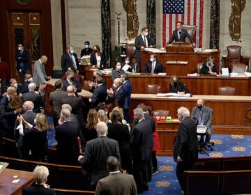 In this image from House Television, Democrats celebrate on the House floor late Friday, Nov. 5, 2021, in Washington, after the House approved a $1 trillion package of road and other infrastructure projects after Democrats resolved a months-long standoff between progressives and moderates, notching a victory that President Joe Biden and his party had become increasingly anxious to claim