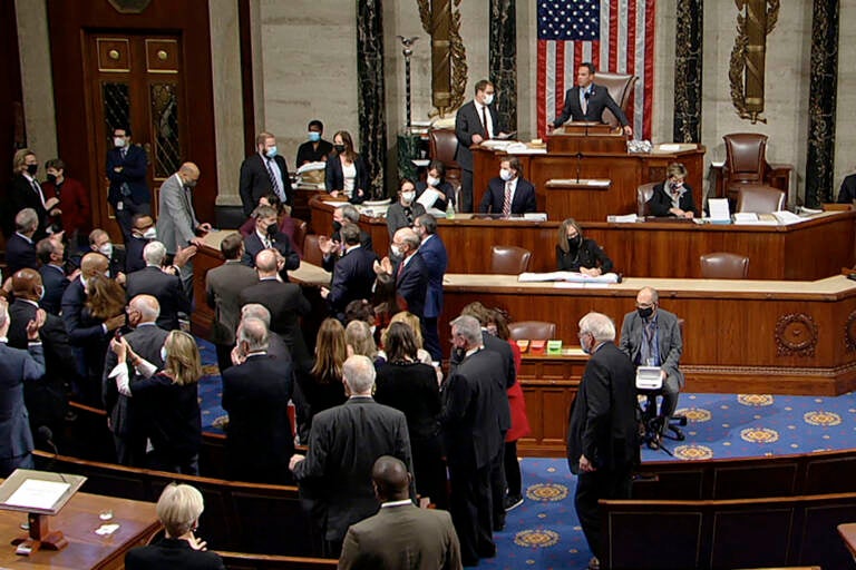 In this image from House Television, Democrats celebrate on the House floor late Friday, Nov. 5, 2021, in Washington, after the House approved a $1 trillion package of road and other infrastructure projects after Democrats resolved a months-long standoff between progressives and moderates, notching a victory that President Joe Biden and his party had become increasingly anxious to claim